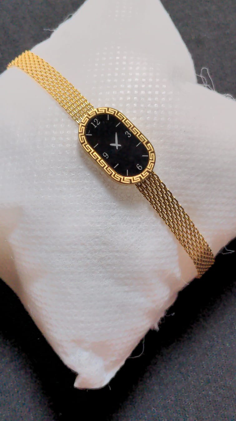 gold-tone Xavier Masterpiece ladies' watch with a black dial and mesh band.